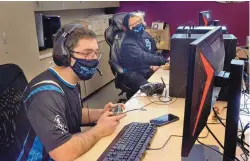  ?? JIM THOMPSON/JOURNAL ?? Senior Ian Gonzales and sophomore Aiden Lindeman get ready for an e-sports match at Del Norte High School. Lindeman says the league’s homework lab helped him improve his algebra grade.