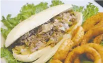  ??  ?? The Philly Cheesestea­k fills a hoagie roll with sliced steak, melted cheese, mushrooms, onions and peppers.