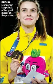  ?? ?? PROUD: Mahuchikh keeps hold of her gold medal on the podium