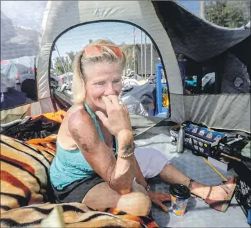  ?? Irfan Khan Los Angeles Times ?? MONICA CORMAN was living in Santa Ana’s Plaza of the Flags in March. The plaza was cleared the following month. Shelters proposed by Santa Ana and two other cities could add 700 beds to help O.C.’s homeless.