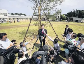  ?? AP/AFP/GETTY ?? Mayor Yukiei Matsumoto speaks to journalist­s in Narahat