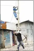  ?? ?? An engineer works on a power line pole in Nairobi, Kenya on May 6, The number of people who have lost their lives in the devastatin­g floods and landslides triggered by heavy rains in Kenya since March has risen to 238, with 75 others still missing, the government said on May 7. (Xinhua)