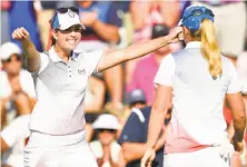  ?? Stuart Franklin / Getty Images ?? Paula Creamer (left) and Austin Ernst of Team USA celebrate a win during afternoon four-ball matches of the Solheim Cup.