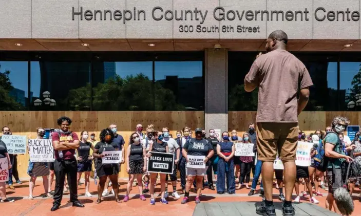  ?? Photograph: Kerem Yucel/AFP/Getty Images ?? Protesters gather outside the Hennepin county Government Center in Minneapoli­s, Minnesota, before Derek Chauvin was charged in the death of George Floyd.