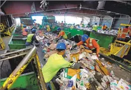  ?? Carolyn Cole Los Angeles Times ?? WORKERS sift through plastic items and trash at a recycling plant in Wilmington. Research on the effect of microplast­ics in humans is still in the early stages.