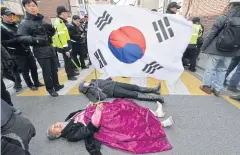  ?? AP ?? Supporters of ousted South Korean President Park Geun-hye lie on the road to block media vehicles, near her private home in Seoul yesterday.