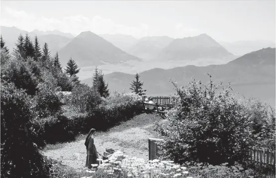  ?? Christy DeSmith photos ?? A nun maneuvers her wheelbarro­w through the gardens at Felsentor, a spiritual retreat on Switzerlan­d’s Mount Rigi.