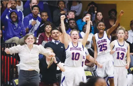  ?? STAFF PHOTOS BY DOUG STRICKLAND ?? Red Bank’s bench reacts as the Lady Lions win their District 6-AA tournament final 44-43 over Tyner at Hixson High School on Tuesday.