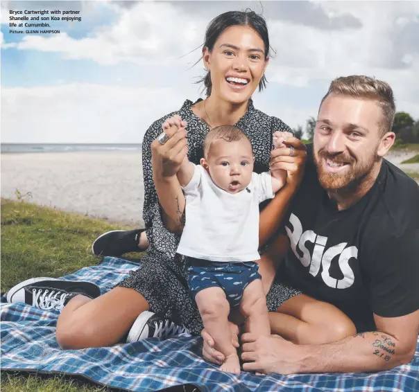  ?? Picture: GLENN HAMPSON ?? Bryce Cartwright with partner Shanelle and son Koa enjoying life at Currumbin.