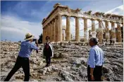  ?? YORGOS KARAHALIS / BLOOMBERG 2017 ?? Chinese tourists take photos in front of the Parthenon last May during a visit to the Acropolis in Athens. Greece is emerging from years of economic crisis with a healthy growth rate.
