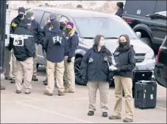  ??  ?? A little late, officers: FBI agents huddle at the scene of the recent Boulder massacre — whose perpetrato­r was well-known to the agency.