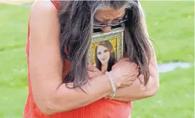  ?? RICK BOWMER/ASSOCIATED PRESS ?? Melany Zoumadakis clutches a photo of her daughter, Tanna Jo Fillmore, in Salt Lake City on April 26. Fillmore killed herself in the Duchesne County Jail in 2016, after repeatedly calling her mother, saying she was being denied her prescripti­on medicines that had stabilized her. Her mother has filed suit.