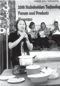  ??  ?? DA senior science researcher Merly Salaver showing the use of adlai as a food source to locals in Manambulan, Davao City.