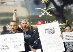  ?? AP ?? A dozen Indonesian journalist­s hold posters with photos of Saudi writer Jamal Khashoggi during a protest outside the Saudi Arabian Embassy in Jakarta, Indonesia, yesterday.