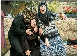  ?? NASSER NASSER/AP ?? Palestinia­n women cry Thursday during the funeral of Yehya Taha, 21, who was reportedly killed during clashes with Israeli troops as they conducted a raid in a West Bank village.