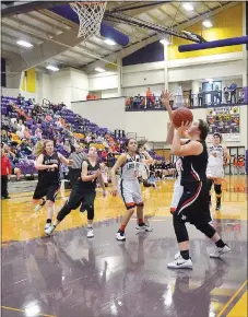  ?? TIMES photograph by Annette Beard ?? Lady Blackhawk Alli Whatley finished the first game of the District Tournament Wednesday with a season-high 20 points in the game against Gentry. The Lady Blackhawks fell Saturday afternoon to the Huntsville Eagles finishing the District Tournament in...