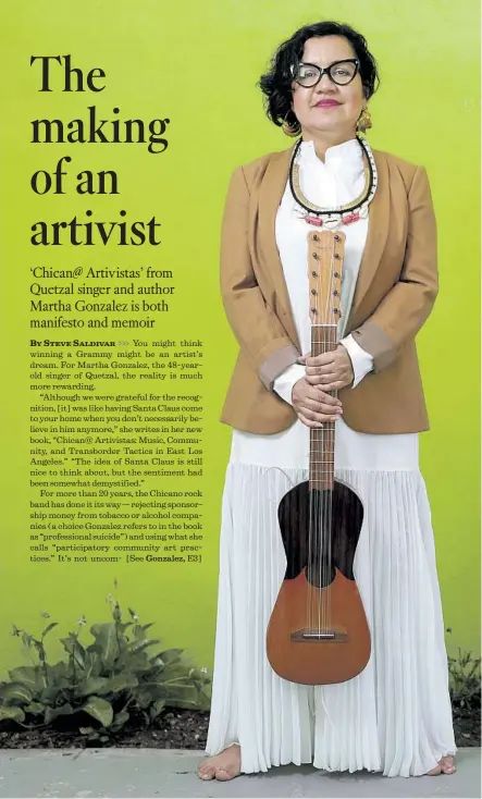  ?? Gary Coronado Los Angeles Times ?? MARTHA GONZALEZ of the band Quetzal, photograph­ed at her home holding a jarana made by Gilberto Gutierrez of Veracruz.