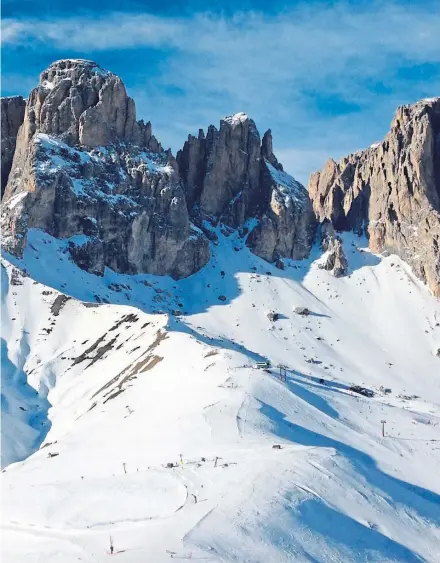  ??  ?? ● The spectacula­r jagged peaks of the Dolomites tower over so many fantastic ski runs