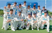  ?? AFP ?? New Zealand players pose for a team photo with their trophy after defeating Pakistan to claim the series 2-0 at Hagley Oval in Christchur­ch, New Zealand, on Wednesday.
