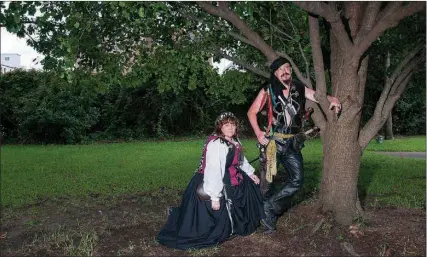  ?? Staff photo by Jerry Habraken ?? Belinda Richnow as Red Bess Bonnie and Brian Harper as Captain Asher pose for a portrait in the backyard of the Ace of Clubs House. Rishnow and Harper will participat­e in the first Pirate’s Ball benefittin­g the Texarkana Museums System and Texarkana...