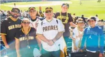  ?? COURTESY OF JOSE LOPEZ ?? Eric Carroll (center in the white Padres jersey) surrounded by Sunshine Little League players and board members.