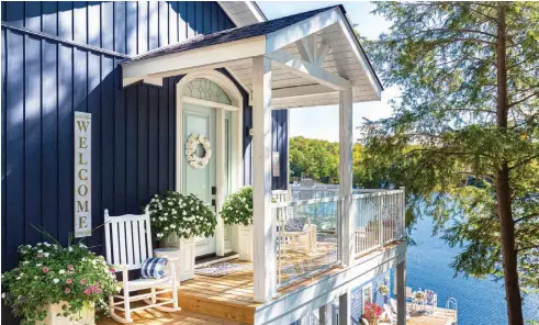  ??  ?? |TOP| PRETTY PORCH. A covered porch area was an addition to the new constructi­on and became Jubilee Haven’s primary entrance. Cedar boards make up the deck, while aluminum siding is durable yet elegant. Nature encircles the cottage and slips right up onto the porch via Impatiens plants, which cascade from the planters. “I like how much they spread and overflow the containers over their growing season,” Janice says.