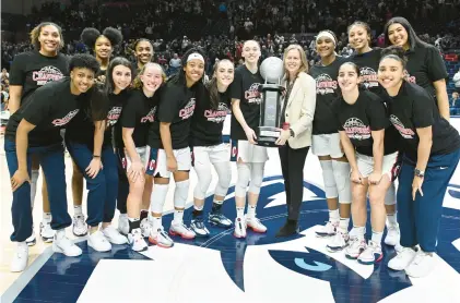  ?? CLOE POISSON/SPECIAL TO THE COURANT ?? As Paige Buckers and the Uconn women’s basketball team took another trophy from Big East commission­er Val Ackerman on Tuesday night, it was a good time to turn a spotlight on the Huskies’ academic achievemen­ts.