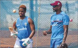  ??  ?? WI batsman Hetmyer (L) bounces a ball with his bat during a practice session ahead of last T20I vs India