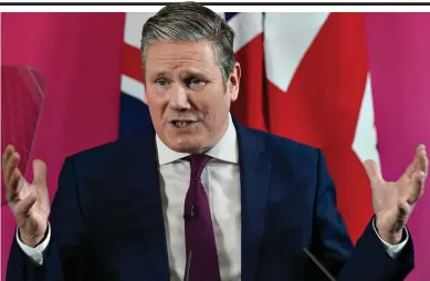  ?? ?? Reborn as John Bull: Sir Keir Starmer delivers speech in front of two Union flags yesterday