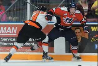  ?? NEWS PHOTO RYAN MCCRACKEN ?? Medicine Hat Tigers captain Clayton Kirichenko lays a body check on Lethbridge Hurricanes captain Tyler Wong in Game 5 of the WHL's Eastern Conference semifinals on Friday at the Canalta Centre.