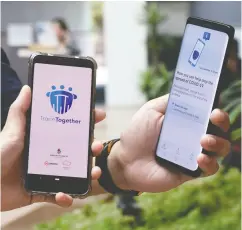  ?? CATHERINE LAI / AFP VIA GETTY IMAGES ?? Government Technology Agency (Govtech) staff demonstrat­e Singapore’s new contact-tracing smartphone app,
used as a preventive measure against COVID-19.