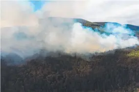  ??  ?? A bushfire burns in the Styx Valley.