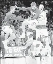  ?? JAE C. HONG / ASSOCIATED PRESS ?? The Wisconsin Badgers, including star forward Sam Dekker (right), are a tight-knit team that is enjoying its run to a second-straight Final Four.