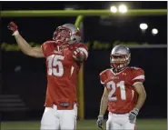  ?? NEWS-HERALD FILE ?? Mentor’s Kurt Laseak raises his arms in the air with a sigh of relief as Mentor narrowly pulled off a victory over Solon in 2011 in Parma. The final score was 42-40.