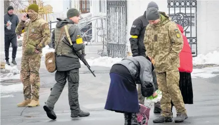  ?? PHOTO / AP ?? Ukraine’s secret service search a parishione­r at the entrance to the Pechersk Lavra monastic complex in Kyiv.