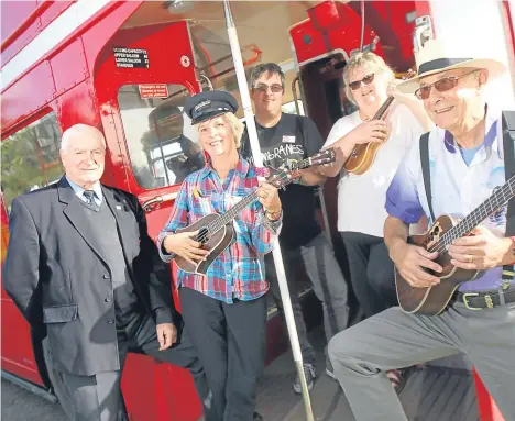  ??  ?? MORE than 30 ukulele enthusiast­s took to the road and boarded a vintage bus in Fife before touring Dundee.
Conducting the musicians aboard the double-decker was John McBeath, who is member of the Happy Ukes in Dundee and Cupalele, based in Cupar....