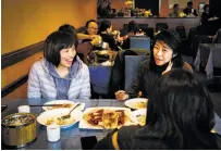  ?? Gabrielle Lurie / The Chronicle ?? Dandan Limketkai (left), Jeannette Bernardo and Jane Koa (back to camera) at Chef Zhao Bistro in San Mateo.