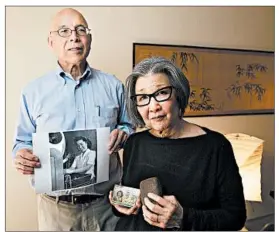  ?? PAUL KITAGAKI JR./SACRAMENTO BEE ?? Yoshinori Toso Himel, left, and Barbara Takei display artifacts from their relatives’ internment during WW II: a photo, an ID card and a cigarette holder made from string.