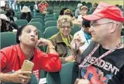  ?? Irfan Khan Los Angeles Times ?? ARTHUR Christophe­r Schaper and Jan Alston get into a heated exchange at a town hall meeting held by Rep. Maxine Waters in Inglewood in May.