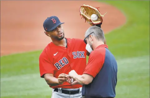  ?? Elise Amendola / Associated Press ?? Xander Bogaerts receives treatment on his hand during training camp at Fenway Park.