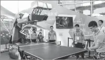  ?? WANG GANG / FOR CHINA DAILY ?? A worker plays table tennis with a robot at the World Artificial Intelligen­ce Conference in Shanghai in September.