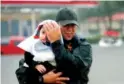  ??  ?? Right: Sgt. Chad Watts, of the Louisiana Department of Wildlife and Fisheries, holds Madelyn Nguyen, 2, after he rescued her and her family.