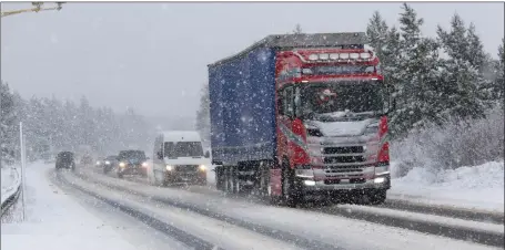  ?? Pictures: Peter Jolly ?? Traffic had to tread carefully on the A9 near Inverness yesterday as blizzards hit the Highlands