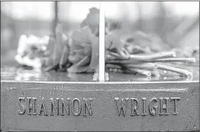  ?? Arkansas Democrat-Gazette/MITCHELL PE MASILUN ?? Fresh flowers sit atop a sundial bearing the names of the victims in the memorial garden. Every sidewalk in the garden was replaced so no child would have to walk where others had died.