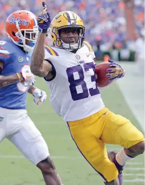  ?? By John Raoux, AP) (Photo ?? LSU wide receiver Russell Gage (83) raises his hand after scoring on a jet sweep in front of Florida defensive back Nick Washington during the first half of Saturday's game.