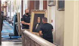  ?? CHIP SOMODEVILL­A GETTY IMAGES ?? Staff remove a portrait of former speaker of the House Robert Hunter of Virginia (1839-1841), who was a Confederat­e official, from the Speaker’s Lobby.