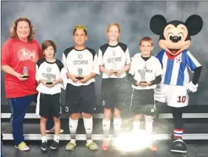  ??  ?? The Heber Springs Storm 03 team won fourth place in the gold division for the team’s age group at the Disney 3v3 Soccer Championsh­ip. From left are coach Kathy Larios, Luca Molina, Thomas Larios, Sterling Thomas, Luke Powell and Mickey Mouse.