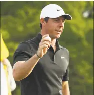  ?? Jamie Squire / Getty Images ?? Rory McIlroy waves on the 18th green during the first round of the 2018 Masters on Thursday in Augusta, Georgia.