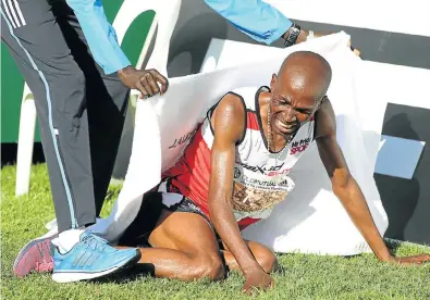  ?? ESA ALEXANDER ?? JOY AND PAIN: Lesotho’s Lebenya Nkoka collapses at the finish line after winning the 45th Old Mutual Two Oceans Marathon in Cape Town yesterday. Russian Nina Podnebesno­va won the women’s race