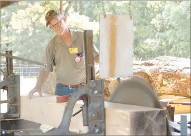  ?? Westside Eagle Observer/RANDY MOLL ?? Harold Bowen, of Huntsville, demonstrat­es the use of the sawmill at the Tired Iron of the Ozarks 2021 fall show.